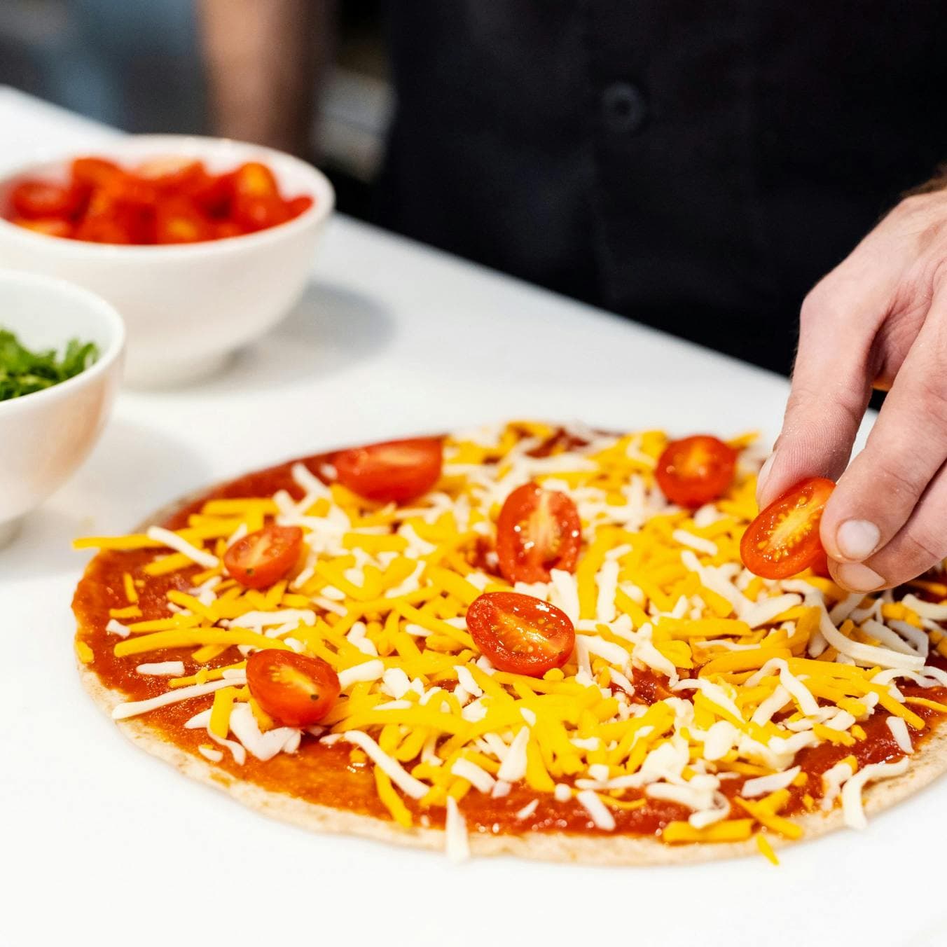 tomato pizza being prepared
